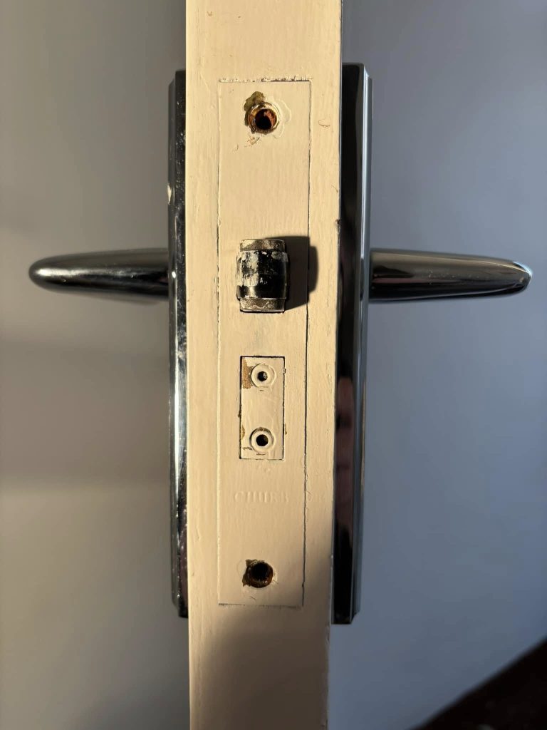 Photo of the doorframe showing the levers on the front and back of the door